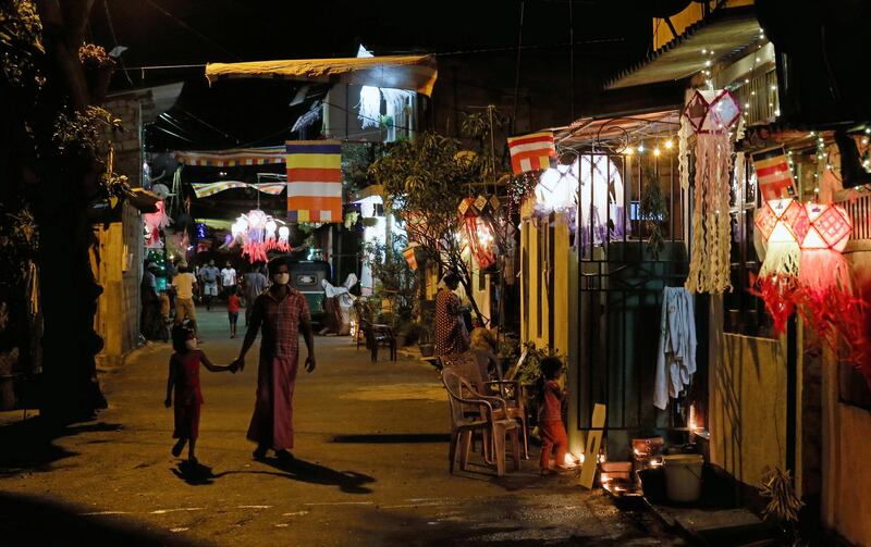 People walk on a road decorated with lights and lanterns on the Vesak Day, which is celebrated in Sri Lanka on May 7th and 8th to commemorate the birth, enlightenment and death of Buddha, in Colombo, Sri Lanka. Reuters