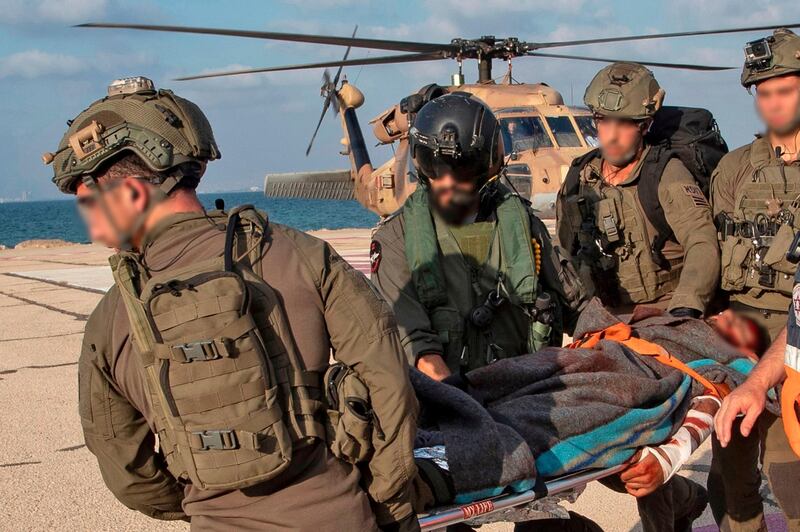 Israeli paramedics and soldiers evacuate a supposedly mock wounded comrade at a helipad in Ramban hospital in the Mediterranean city of Haifa, Israel. All photos by AFP