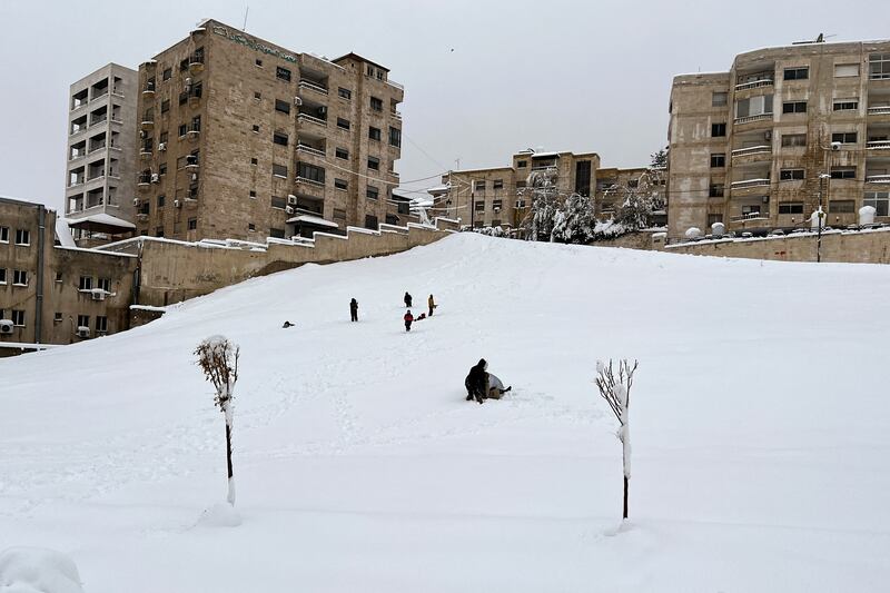 People play in the snow in Amman, Jordan, on January 27, 2022. Reuters