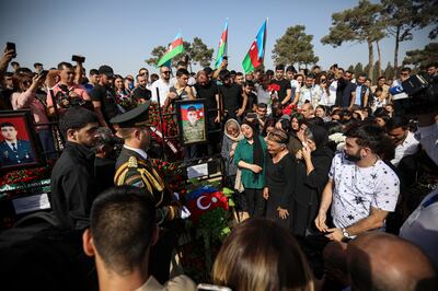 Mourners at a mass funeral for Azerbaijani soldiers killed during clashes with Armenian troops, at the cemetery near Baku on Wednesday. EPA