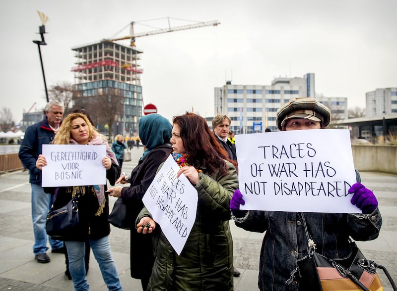 Protesters outside the International Criminal Tribunal for Former Yugoslavia in The Hague, on March 24, 2016, before the verdict in the trial of former Bosnian Serb leader Radovan Karadzic. He was found guilty of genocide and sentenced to 40 years in jail over the worst atrocities in Europe since the Second World War. AFP