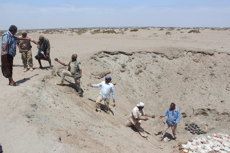 Yemeni security forces inspect unexploded ordnance confiscated from Houthi rebels. Saleh Al Obeidi / AFP