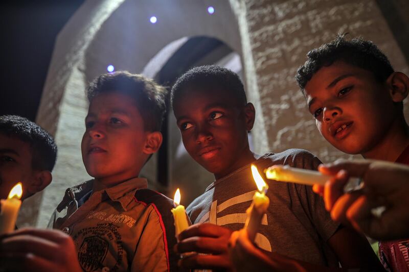 Palestinian children hold candles during a march in solidarity with the Lebanese people in Rafah's refugee camp, southern Gaza Strip.  EPA