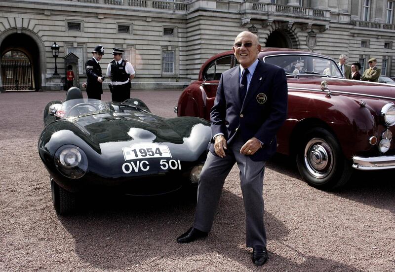 Stirling Moss poses with his 1954 Jaguar D Type outside Buckingham Palace in London in 2006. AFP