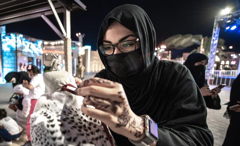 Abu Dhabi, United Arab Emirates, November 23, 2020.   Sheikh Zayed Heritage Festival celebrations at Al Wathba.  Zainab Ali Abedelnabi, ties the hood of the falcon.
Victor Besa/The National
Reporter:  Samia Badih
Section:  NA
For:  Standalone/Stock