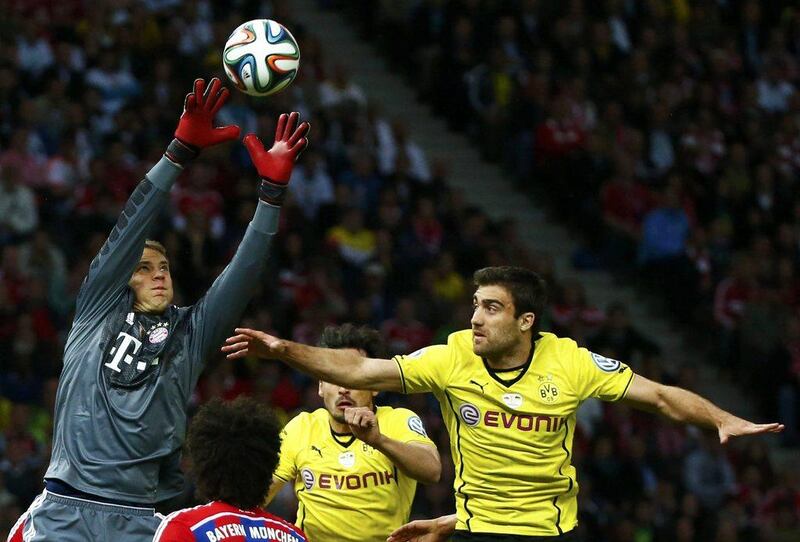 Bayern Munich keeper Manuel Neuer makes a save under pressure from Borussia Dortmund's Sokratis Papastathopoulos during the German Cup final. Michael Dalder /Reuters / May 17, 2014