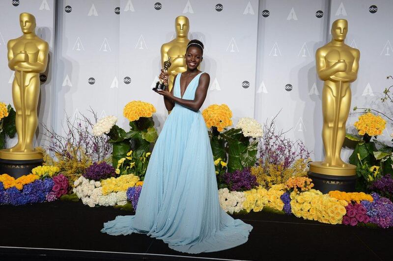 ]Lupita Nyong'o poses in the press room with the award for best actress in a supporting role for "12 Years a Slave" during the Oscars at the Dolby Theatre on March 2, 2014, in Los Angeles.  Jordan Strauss / Invision / AP