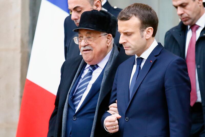 French President Emmanuel Macron, right, accompanies Palestinian President Mahmoud Abbas after their meeting at the Elysee Palace in Paris, Friday, Dec. 22, 2017. Abbas visits France in the hopes that France takes a leading role in opposing the US recognition of Jerusalem as Israel's capital. (AP Photo/Francois Mori)