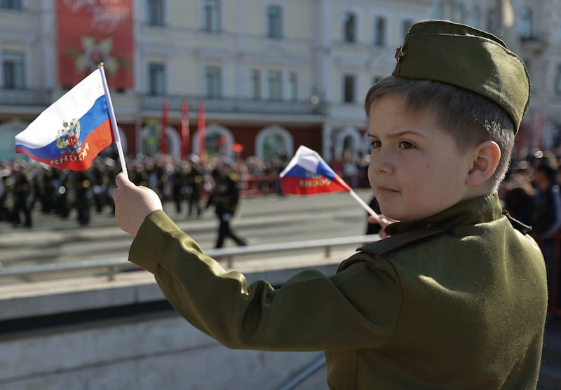 A boy wearing a Red Army-styled uniform watches a military parade in Vladivostok. Reuters