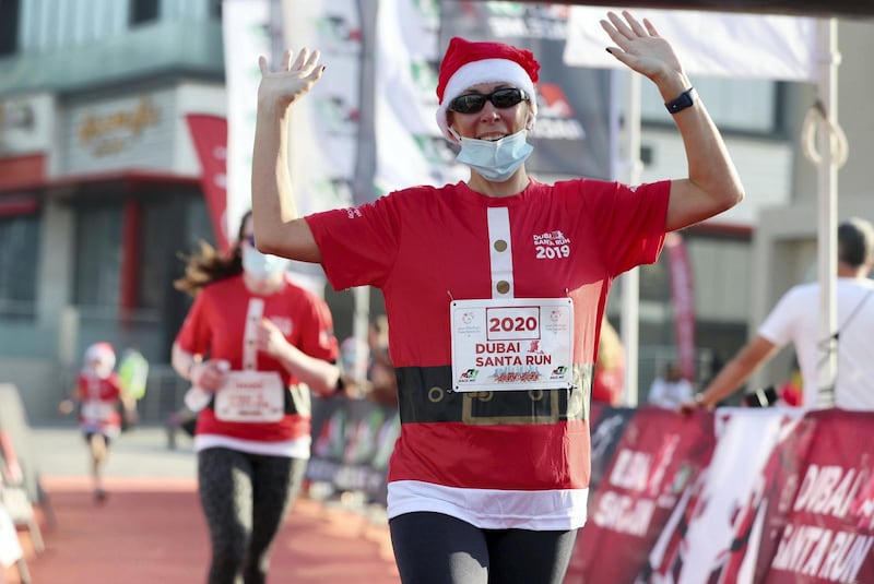 Dubai, United Arab Emirates - December 11, 2020: People take part in the Santa fun run at Dubai festival city. Friday, December 11th, 2020 in Dubai. Chris Whiteoak / The National