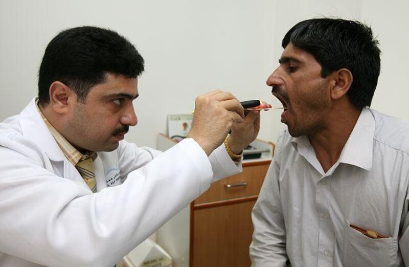 Dr Safdar Reza examines Farid Hussain at Jebel Ali Hospital Corporate Clinic in Dubai.