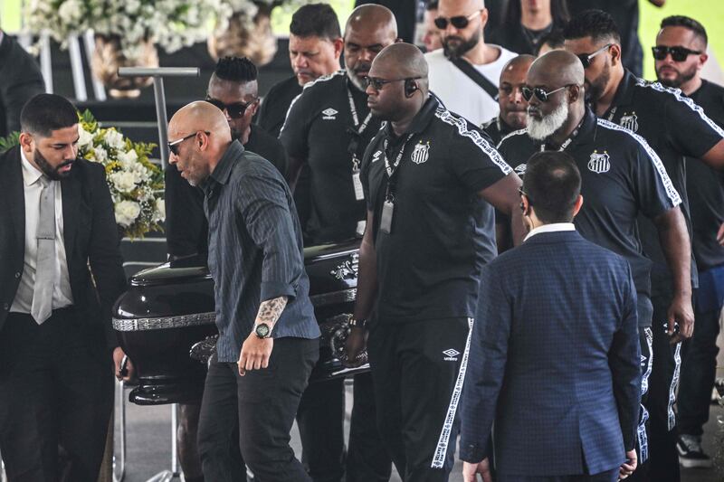 The casket of Brazilian great Pele is moved into the Urbano Caldeira Stadium in Santos. AFP