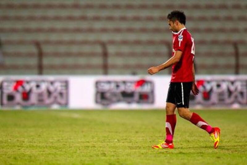 Luis Jimenez walks off the pitch after being sent off for butting a referee during Al Ahli's 2-1 win against Al Jazira.