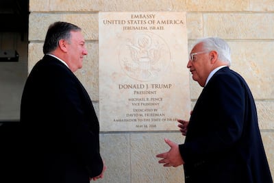 US Secretary of State Mike Pompeo and US ambassador to Israel David Friedman stand next to the dedication plaque at the US embassy in Jerusalem on March 21, 2019. / AFP / POOL / JIM YOUNG
