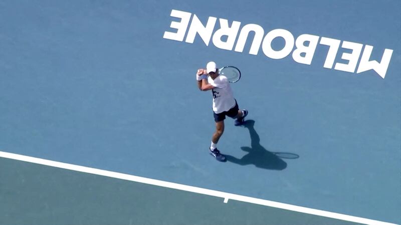 In this image taken from aerial video footage, Novak Djokovic is seen training at Melbourne Park on Tuesday, January 11 following his release from detainment over the cancellation of his visa to play in the Australian Open. AFP