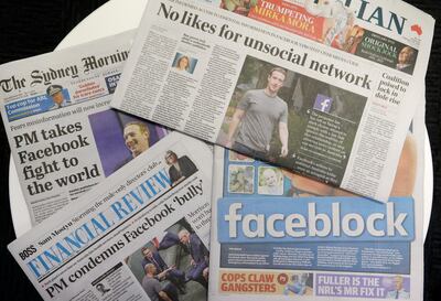 Front pages of Australian newspapers are displayed featuring stories about Facebook in Sydney, Friday, Feb. 19, 2021. In a surprise retaliatory move Thursday, Facebook blocked Australians from sharing news stories, escalating a fight with the government over whether powerful tech companies should have to pay news organizations for content. (AP Photo/Rick Rycroft)