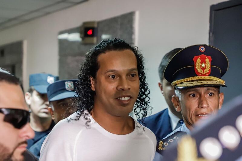 Former Brazil forward Ronaldinho arrives at Asuncion's Justice Palace to testify. EPA