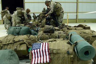 US Marines arrange their equipment as US troops arrive in Kandahar after their withdrawl from the Camp Bastion-Leatherneck complex in Helmand province on October 26, 2014.  AFP