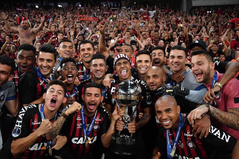 Atletico Paranaense's players celebrate with the trophy after winning the 2018 Copa Sudamericana at the Arena da Baixada stadium in Curitiba, Brazil. AFP