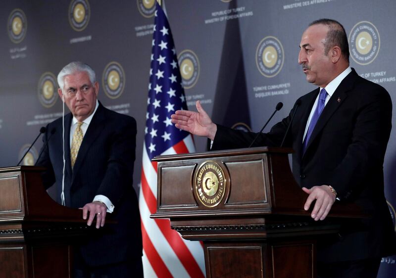 Turkish Foreign Minister Mevlut Cavusoglu (R)and US Secretary of State Rex Tillerson respond to questions during a joint press conference following their meeting in Ankara, Turkey on February 16, 2018.   / AFP PHOTO / ADEM ALTAN