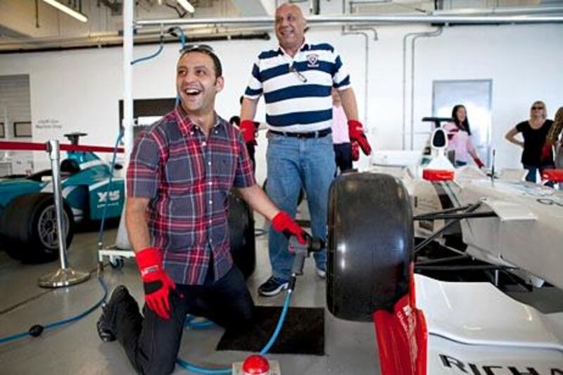 Abu Dhabi, United Arab Emirates, May 27, 2013:    People take part in the Yas Central experience, changing tires on a racing car, during a corporate open day at the Yas Marina Circuit in Abu Dhabi on May 27, 2013. Christopher Pike / The National\

