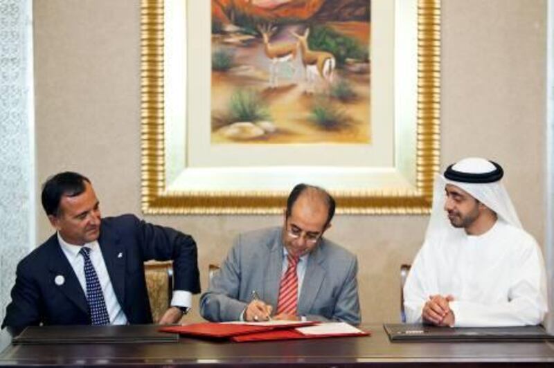 ABU DHABI, UNITED ARAB EMIRATES ‚Äì June 9, 2011:  Franco Frattini, Italian Minister For Foreign Affairs, left, and HH Sheikh Abdullah bin Zayed bin Sultan Al Nahyan, Minister of Foreign Affairs, right, sign an agreement with Mahmoud Jibril, middle, recognizing the National Transitional Council.  ( Andrew Henderson / The National )

