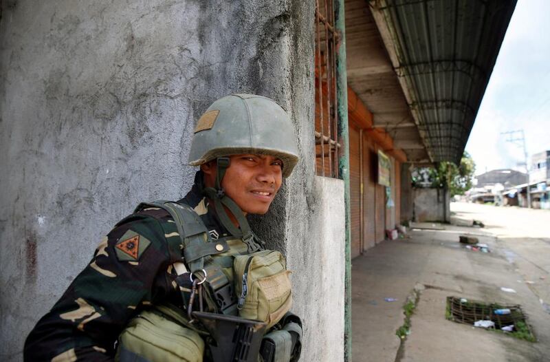 A soldier guards a road in Marawi City as fighting rages between government soldiers and the Maute militant group, in southern Philippines. Erik De Castro / Reuters