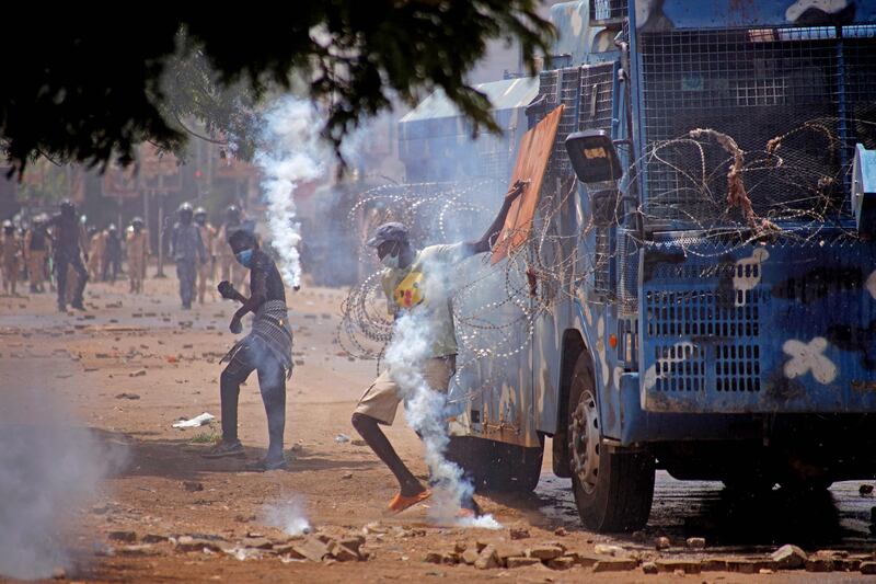 A makeshift wooden shield offers little protection from tear gas. AFP