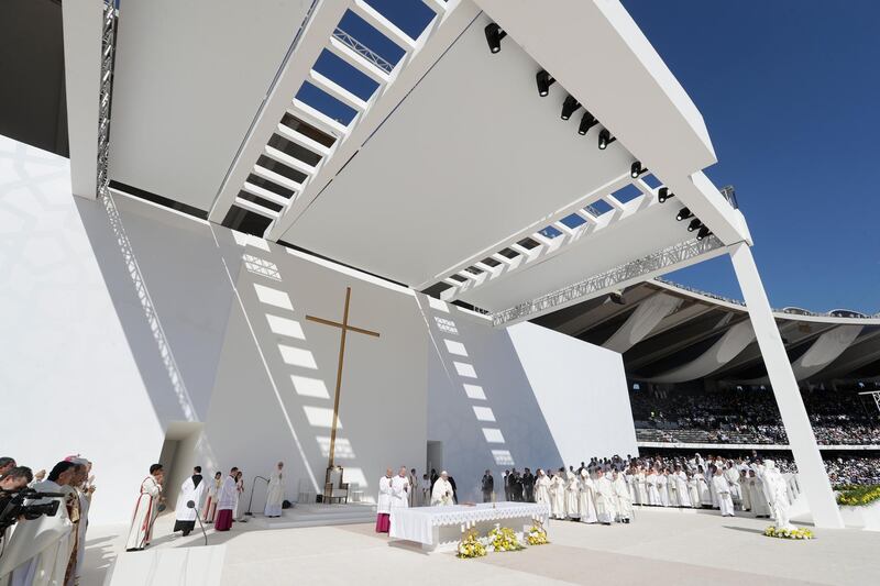 Pope Francis, background centre, celebrates Mass at Zayed Sports City . AP Photo