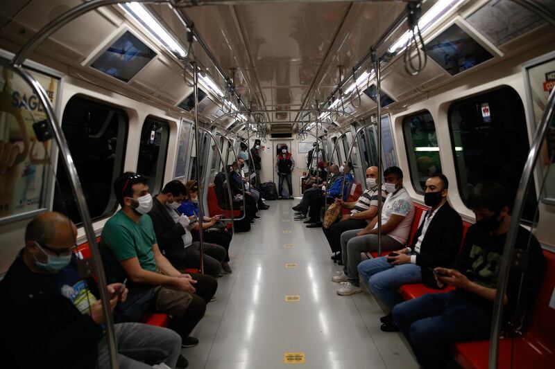 People observe social distancing on a metro carriage in Istanbul, a few hours before the weekend lockdown because of the coronavirus. Teenagers were able to leave their homes for the first time in 42 days on Friday, as their turn came for a few hours of respite from Turkey's coronavirus lockdowns. Turkey has subjected people aged 65 and over and those younger than 20, to a curfew for the past several weeks. AP Photo