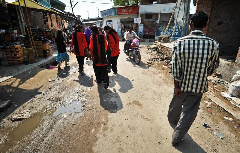 Young women from the Red Brigade walk through the Midiyav slum in the city of Lucknow. The Red Brigade was formed in November 2010 to fight back against a growing number of sexual attacks on women in the Madiyav area of the city of Lucknow, in Uttar Pradesh state, India.
The group of young women wear distinctive red and black salwar kameez. Most have been victims of sexual assault and have resolved that they will take no more. They take direct action against their tormentors and now when a local man steps out of line, he can expect a visit from the Red Brigade and a thrashing.