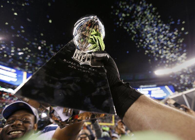 Seahawks players celebrate with the NFL's championship Vince Lombardi trophy after their victory over the Denver Broncos on Sunday. Carlo Allegri / Reuters