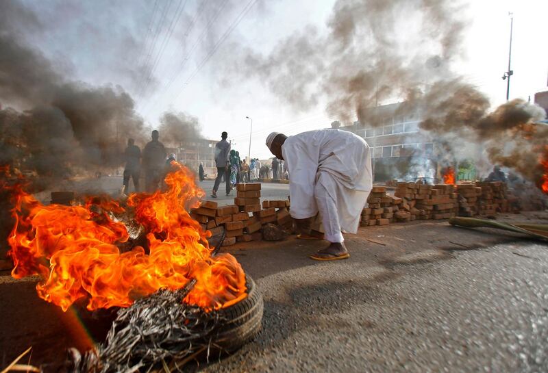 Sudanese protesters close Street 60 with burning tyres and paving stones as the military forces tried to disperse the sit-in outside Khartoum's army headquarters. AFP
