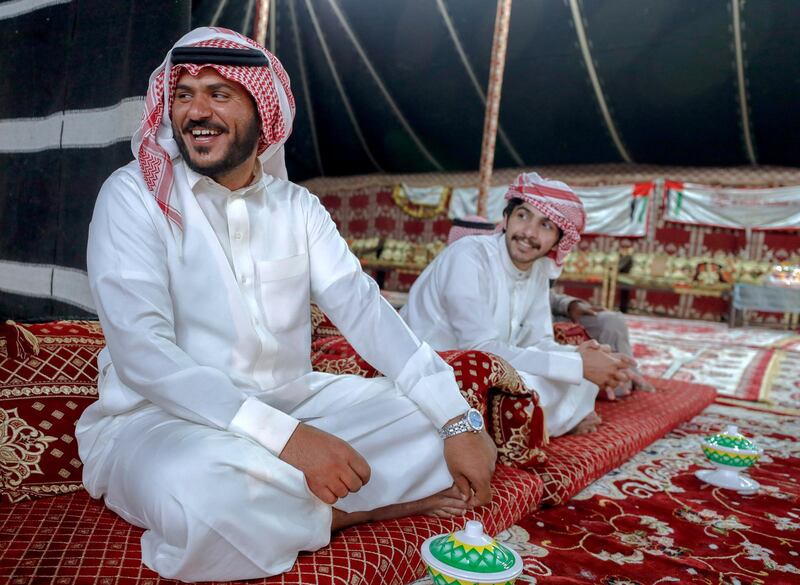 Abu Dhabi, United Arab Emirates, December 10, 2019.    -- (Left) Fahd Al Dossari from Saudi Arabia relaxes after a victory at the Al Dhafra Festival in Abu Dhabi, UAE.Victor Besa/The NationalSection:  NAReporter:  Anna Zacharias