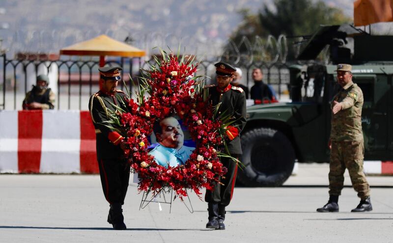 epa07101732 Afghan soldiers carry a floral wreath with a photo of late Abdul Jabbar Qaharmaan, a prominent Afghan politician and candidate of the upcoming Parliamentary elections, who was killed a day earlier in a bomb attack in Helmand, during his funeral ceremony in Kabul, Afghanistan, 18 October 2018. More than 2,500 candidates are running for the 249 seats in the Afghan Parliament, with the 20 October elections denounced by insurgents as a flawed process aimed at legitimizing the presence of foreign troops in Afghanistan. The Afghan government has deployed 54 thousand soldiers to secure the peace during the polls, but 2,384 of the 7,384 polling stations are in areas under Taliban control and will remain closed on election day, according to the country's Independent Election Commission.  EPA/JAWAD JALALI