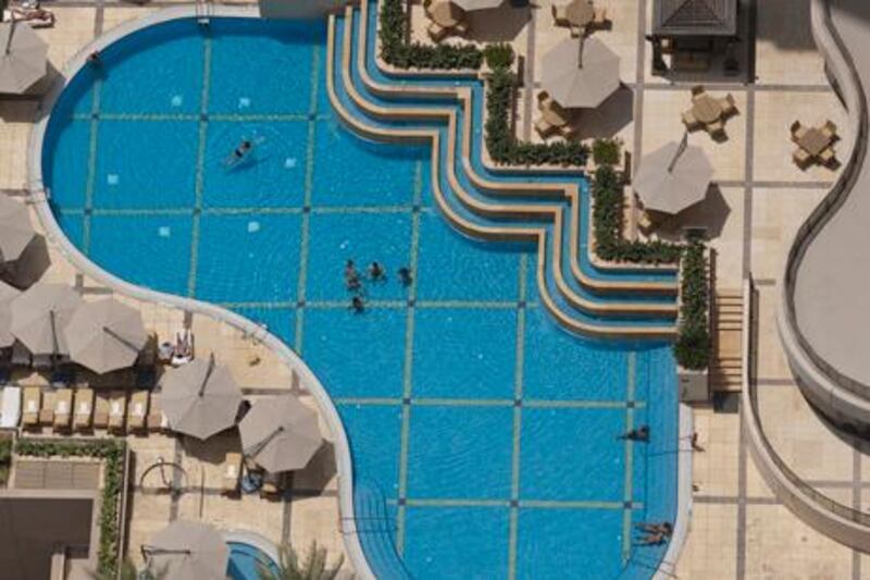 August 27, 2011 - Residents of Dubai Marina enjoy the pool in a residential building. Pawel Dwulit / The National

