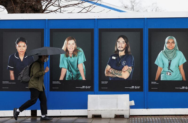 Images of NHS workers displayed on hoardings outside a temporary field hospital at St George's Hospital in London. The UK declared 141,472 new Covid-19 cases on Sunday, a sharp reduction from the more than 200,000 reported daily over the Christmas and New Year period. Reuters