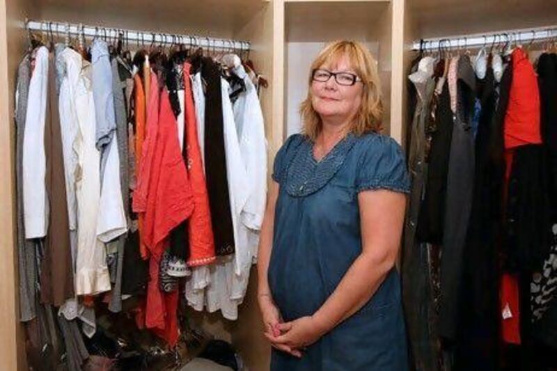 Paula Horsfall, a self-professed "recessionista", shows off some of her clothes at her apartment on the Palm Jumeirah in Dubai. Pawan Singh / The National (w)