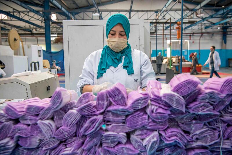 A factory worker packages disposable protective masks along a production line in Morocco's Casablanca. AFP