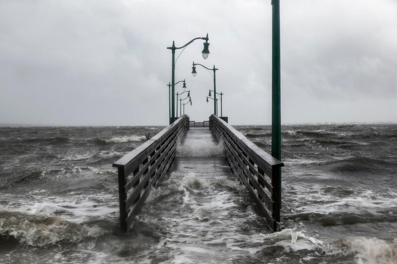 Strong gusts of wind and bands of heavy rain cover a walkway at the Jensen Beach Causeway Park in Jensen Beach, Florida. AFP