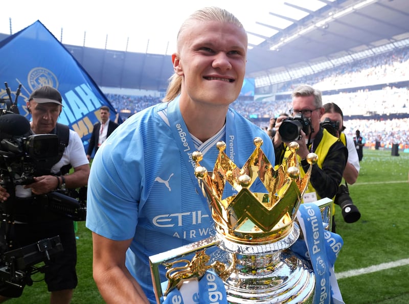 Manchester City's Erling Haaland celebrates with the trophy. PA