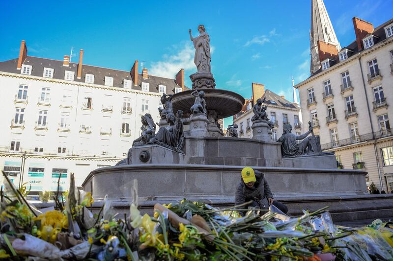 A FC Nantes football club supporter places flowers in the main square of Nantes. AFP