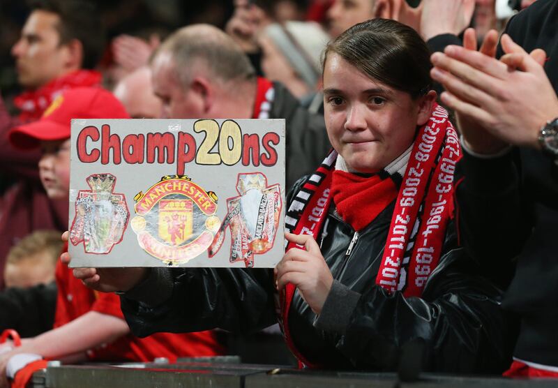 MANCHESTER, ENGLAND - APRIL 22: A Manchester United fan displays a sign to highlight the 20 league titles the team have won during the Barclays Premier League match between Manchester United and Aston Villa at Old Trafford on April 22, 2013 in Manchester, England.  (Photo by Alex Livesey/Getty Images) *** Local Caption ***  167219931.jpg