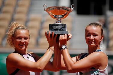 Barbora Krejcikova, right, and Katerina Siniakova lift the women's doubles trophy after beating Iga Swiatek and Bethanie Mattek-Sands in the French Open final. Reuters