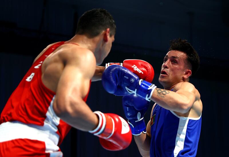 Jafarov Saidjamshid of Uzbekistan (red) slugs it out with Sulaiman of Afghanistan (blue) in a men's middleweight 75kg preliminary bout on day one of the Asian Boxing Championships. Getty Images