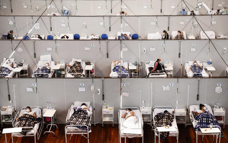 Covid-19 patients rest while being treated at a field hospital set up in the Pedro Dell’Antonia Sports Complex in Santo Andre, Brazil. Getty 