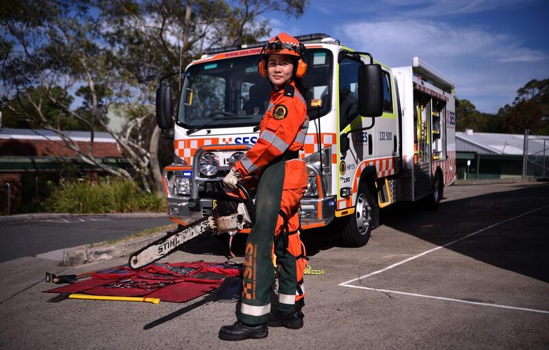 New South Wales state emergency services (SES) volunteer Michelle Whye posing in uniform in front of an emergency vehicle at their headquarters in Sydney. Peter Parks / AFP Photo