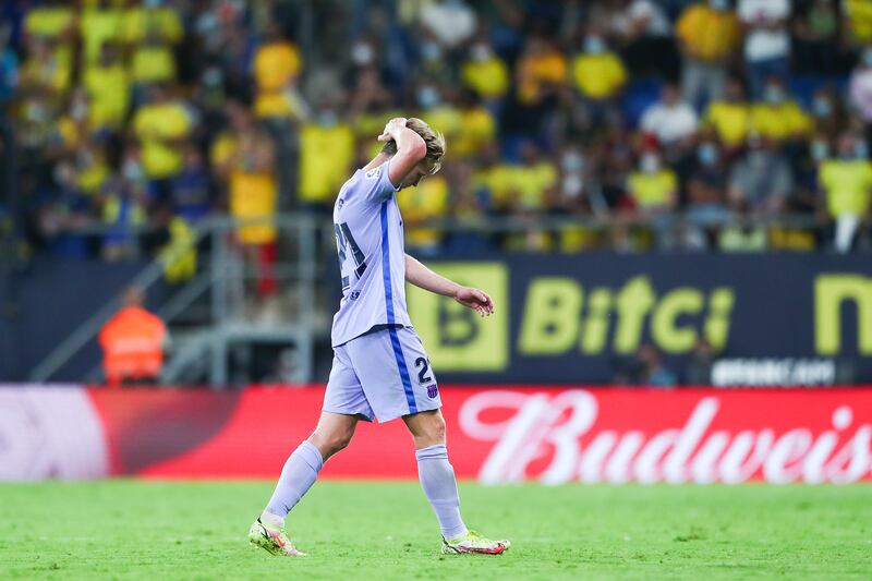 Frenkie de Jong walks off the pitch after being shown a red card. Getty Images