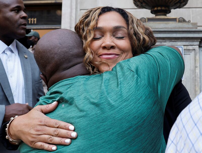 Ms Mosby is embraced by a supporter after the judge overturned the murder conviction. Reuters