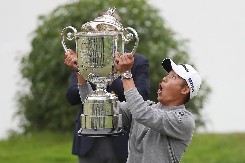 American golfer Collin Morikawa looks worried as the lid falls off the Wanamaker Trophy after he secured victory in the USPGA Championship at TPC Harding Park on Sunday, August 9. AFP